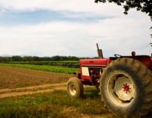 Tractor with agriculture fields in background